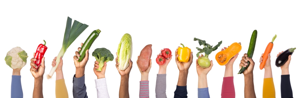 kids hands coming up from bottom of image holding various produce